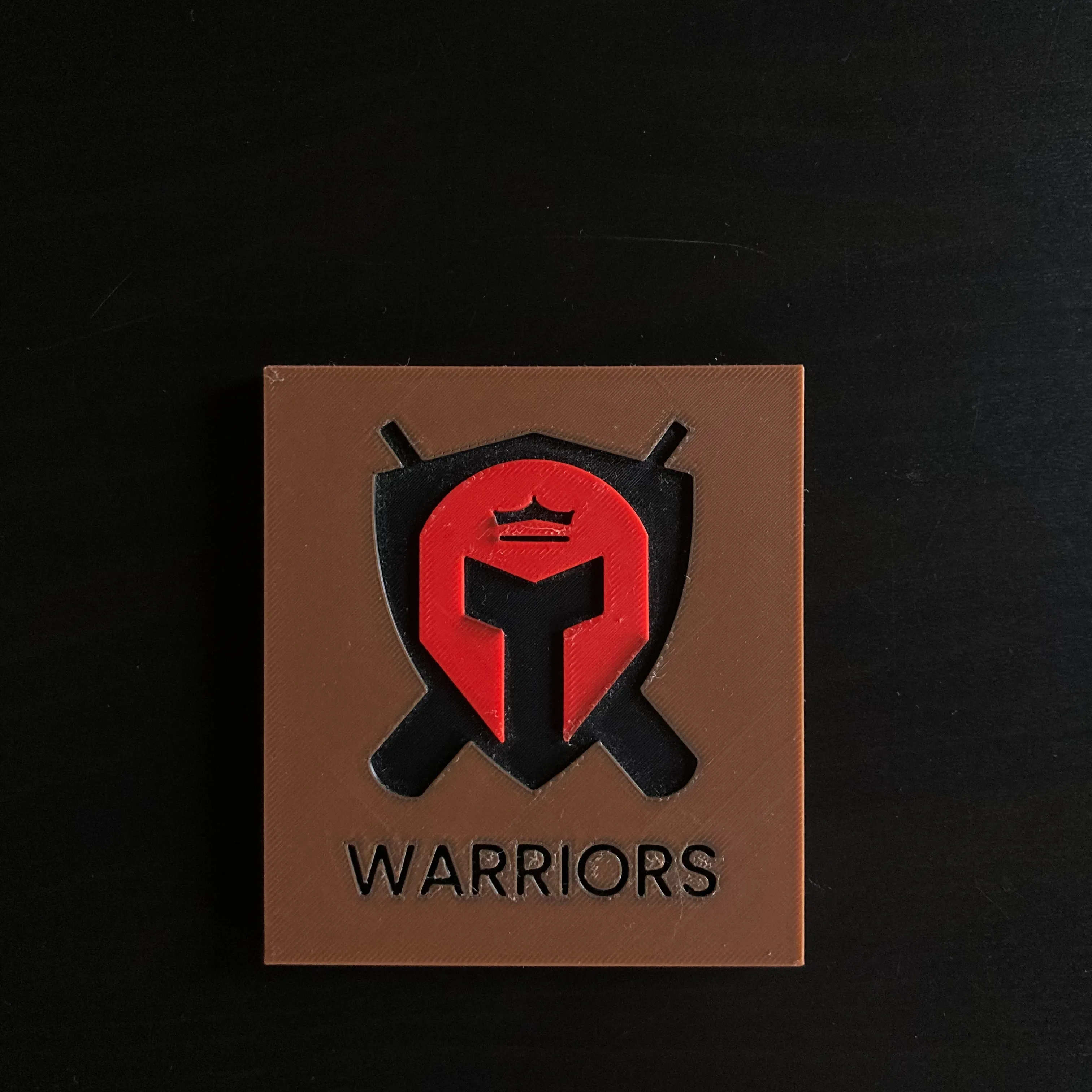 3D printed Warriors logo fridge magnet in brown, red and black