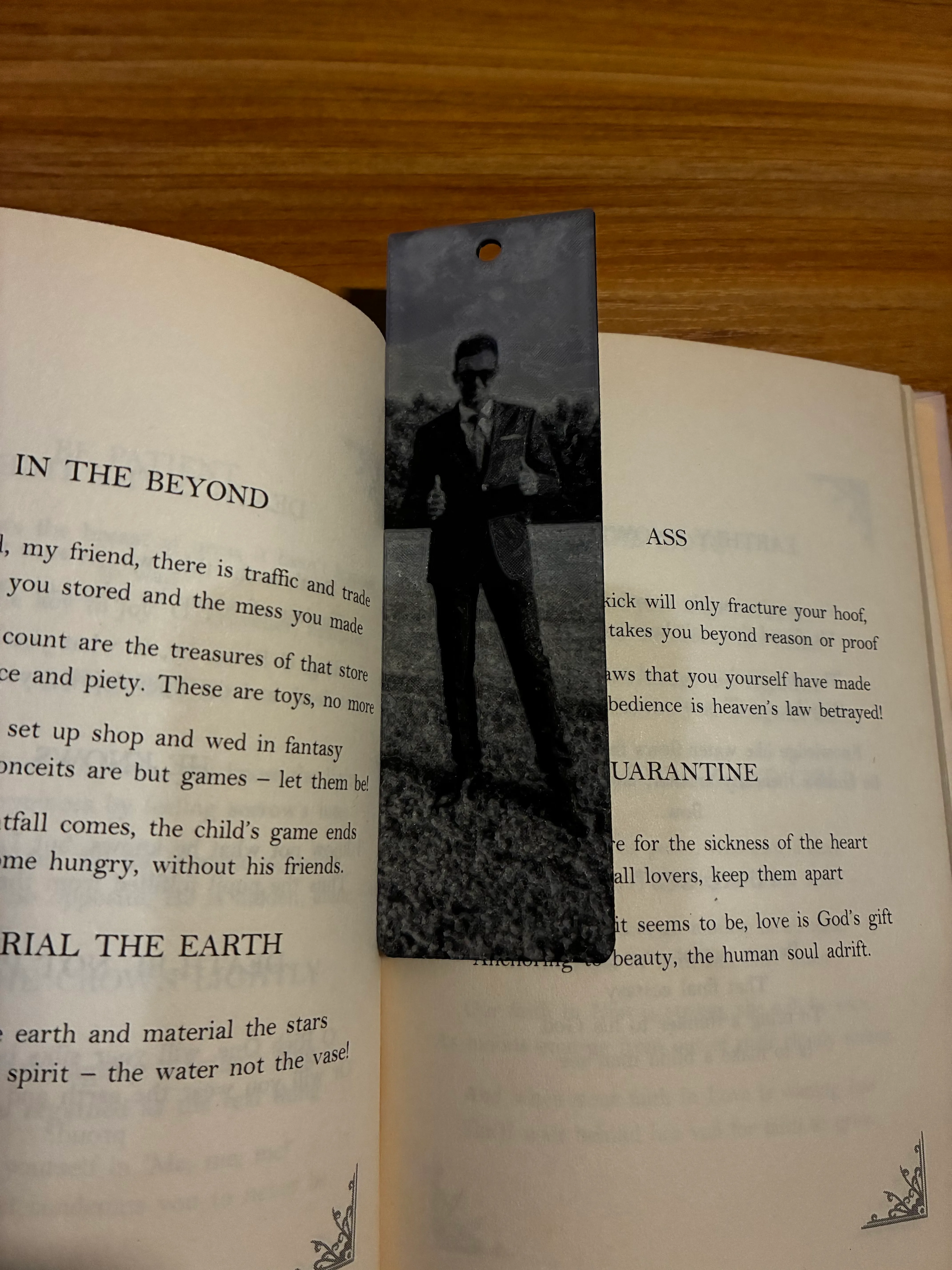 3D printed photo bookmark lying in an open book